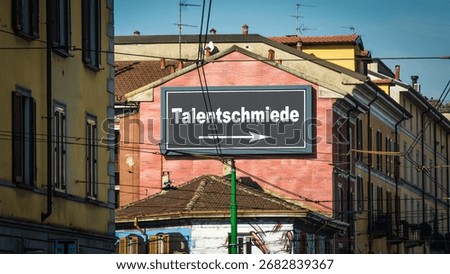 An image with a signpost in German pointing in the direction of the talent factory.