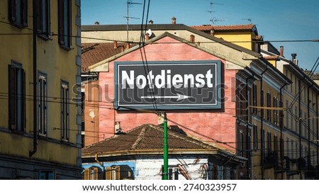An image with a signpost in German pointing in the direction of the emergency service.