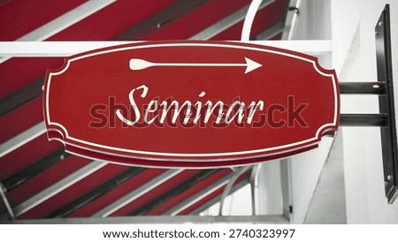 An image with a signpost in German, pointing in the direction of the seminar.