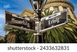 An image with a signpost pointing in two different directions in German. One direction points to success, the other points to failure.