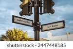 An image with a signpost pointing in two different directions in German. One direction points to I can, the other points to resignation.