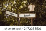 An image with a signpost pointing in two different directions in German. One direction points to friends, the other points to enemies.