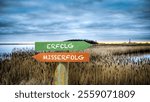 An image with a signpost pointing in two different directions in German. One direction points to success, the other points to failure.