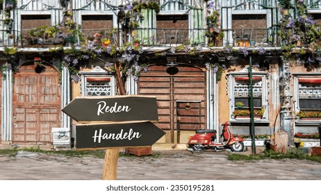 An image with a signpost pointing in two different directions in German. One direction points to action, the other points to speech.