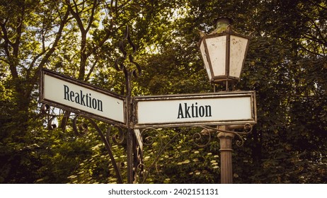 An image with a signpost pointing in two different directions in German. One direction points to action, the other points to reaction.