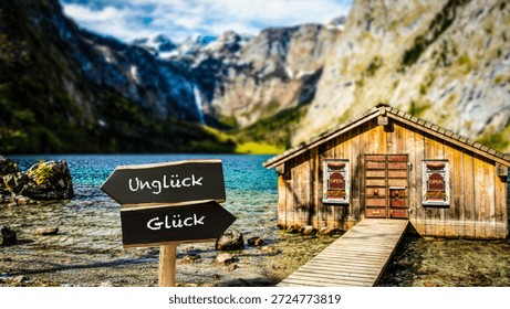An image with a signpost pointing in two different directions in German. One direction points to happiness, the other points to misfortune.