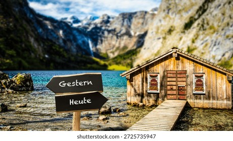 An image with a signpost pointing in two different directions in German. One direction points to today, the other points to yesterday.