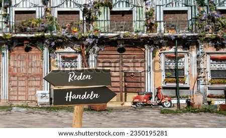 An image with a signpost pointing in two different directions in German. One direction points to action, the other points to speech.