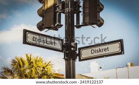 An image with a signpost pointing in two different directions in German. One direction points to Discreet, the other points to Indiscreet.