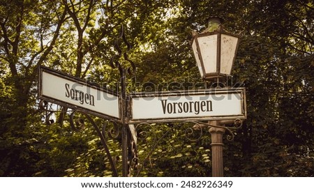An image with a signpost pointing in two different directions in German. One direction points to precautions, the other points to worries.