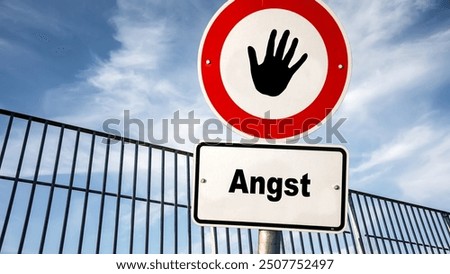 An image with a signpost pointing in two different directions in German. One direction points to courage, the other points to fear.
