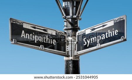 An image with a signpost pointing in two different directions in German. One direction points to sympathy, the other points to antipathy.