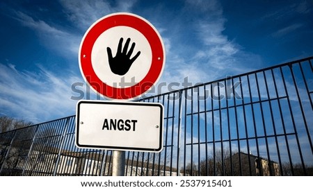 An image with a signpost pointing in two different directions in German. One direction points to courage, the other points to fear.