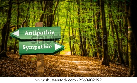 An image with a signpost pointing in two different directions in German. One direction points to sympathy, the other points to antipathy.