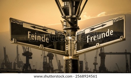 An image with a signpost pointing in two different directions in German. One direction points to friends, the other points to enemies.