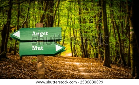 An image with a signpost pointing in two different directions in German. One direction points to courage, the other points to fear.