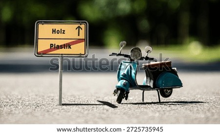 An image with a signpost pointing in two different directions in German. One direction points to wood, the other points to plastic.