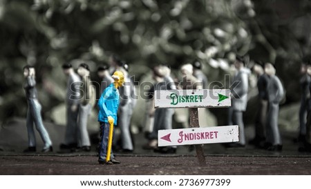 An image with a signpost pointing in two different directions in German. One direction points to Discreet, the other points to Indiscreet.