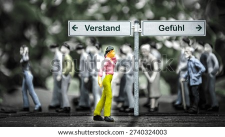 An image with a signpost pointing in two different directions in German. One direction points by feeling, the other points by reason.