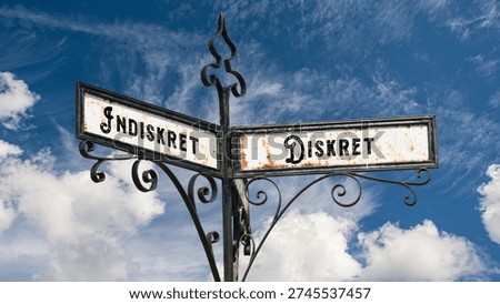 An image with a signpost pointing in two different directions in German. One direction points to Discreet, the other points to Indiscreet.