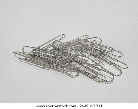 Image of silver paper clip or metal paper clip isolated on white background