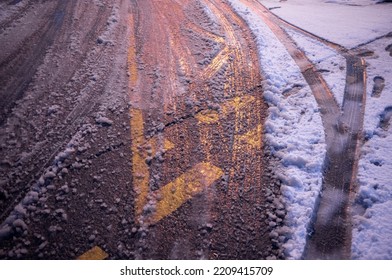 Image Of Slushy Ground Texture After A Snowstorm. Road Markings Visible Through The Snow. Morning Sun Shining On Snow