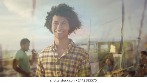 Image of smiling biracial man with friends at beach over grass. happy holidays and free time, digitally generated image. - Powered by Shutterstock