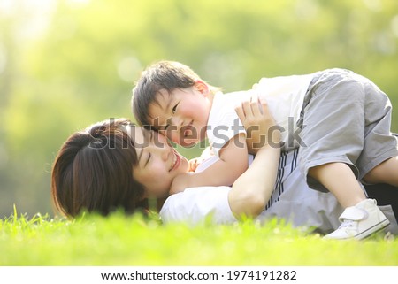 Similar – Mother playing with her daughter on the grass