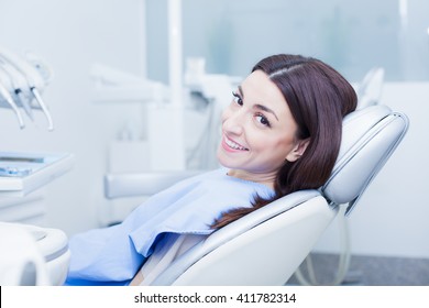 Image Of Smiling Patient Looking At Camera At The Dentist Chair
