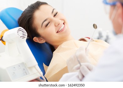 Image Of Smiling Patient Looking At The Dentist