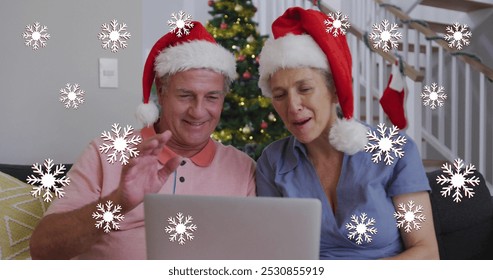 Image of snowflakes over senior caucasian couple wearing santa hats and using tablet. Christmas, tradition and celebration concept digitally generated image. - Powered by Shutterstock