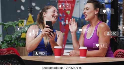 Image of social media data processing over caucasian women in sportswear using smartphone. Global sports, science, digital interface and data processing concept digitally generated image.