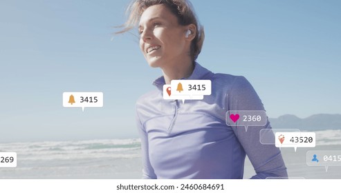 Image of social media data processing over caucasian woman with smartphone on beach. Global fitness, networks, computing, digital interface and data processing concept digitally generated image.