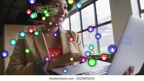 Image of social media data processing over african american businesswoman in office. Global business, computing, digital interface and data processing concept digitally generated image.