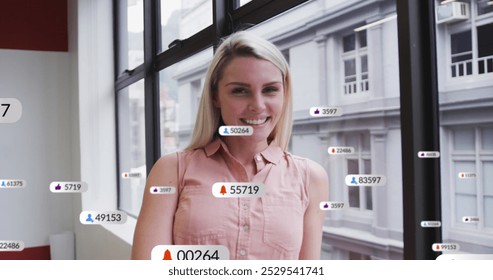 Image of social media data processing over caucasian businesswoman in office. Global connections, business, finance, data processing and digital interface concept digitally generated image.