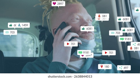 Image of social media icons with growing numbers over albino african american man. Global social media, technology and digital interface concept digitally generated image.