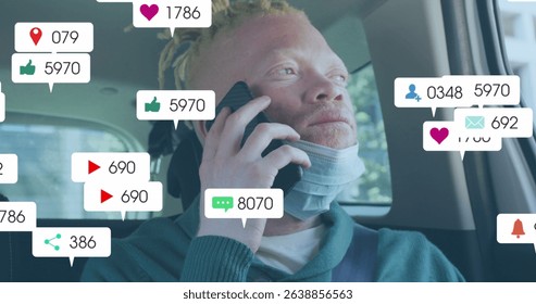Image of social media icons with growing numbers over albino african american man. Global social media, technology and digital interface concept digitally generated image.