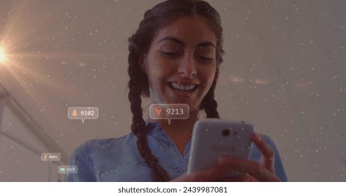 Image of social media icons with numbers over biracial woman using smartphone. Global social media, technology and digital interface concept digitally generated image. - Powered by Shutterstock