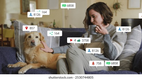 Image of social media icons and numbers over caucasian woman with pet dog at home. Global social media, data processing and digital interface concept digitally generated image.