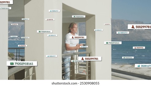 Image of social media icons on banners over caucasian man drinking coffee on balcony by seaside. social media, digital interface and connections concept digitally generated image. - Powered by Shutterstock