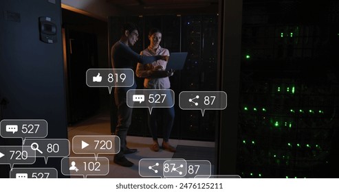 Image of social media icons over diverse male and female engineer using laptop at server room. Social media networking and business data storage technology concept - Powered by Shutterstock