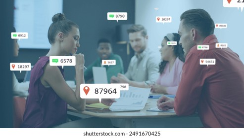 Image of social media icons over diverse man and woman discussing over a document at office. Social media networking and business technology concept - Powered by Shutterstock