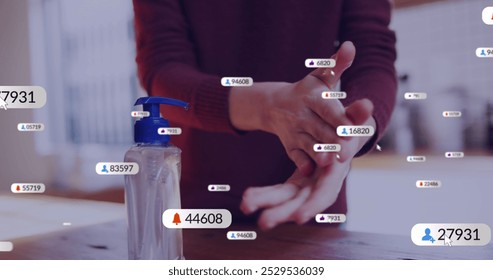 Image of social media icons over mid section of caucasian woman using hand sanitizer at home. Social media networking technology and hygiene concept - Powered by Shutterstock