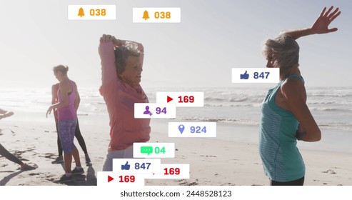 Image of social media notifications, over senior women exercising on beach. social media, positive feelings, wellbeing and communication network concept, digitally generated image. - Powered by Shutterstock