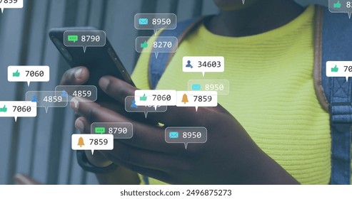 Image of social media notifications over happy african american woman using smartphone in city. Lifestyle, city, digital interface, social network and communication, digitally generated image. - Powered by Shutterstock