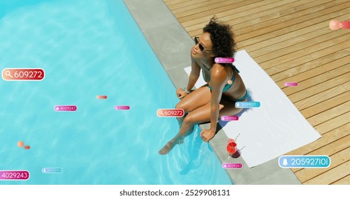 Image of social media notifications over biracial woman sitting by sunny pool. Relaxation, vacations, social network, digital interface, internet and communication, digitally generated image. - Powered by Shutterstock