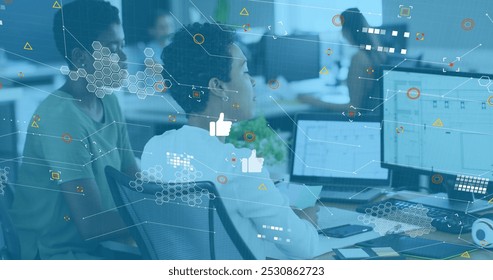 Image of social media reactions and icons over diverse female coworkers in office. Social media, communication, business and technology concept digitally generated image. - Powered by Shutterstock