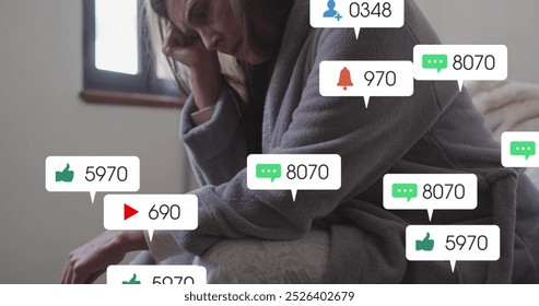 Image of social media text and icons over caucasian woman stressed at home. Global social media, digital interface, computing and data processing concept digitally generated image. - Powered by Shutterstock