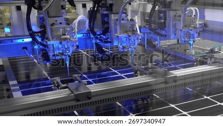 Image of solar panel manufacturing process using robotic and automation technology. Suitable for renewable technology and industrial sustainability themes.