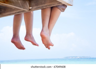 Image of soles of two people lying on sandy beach - Powered by Shutterstock